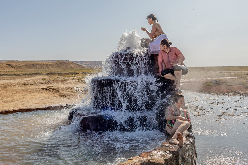 Women sit in a hot spring