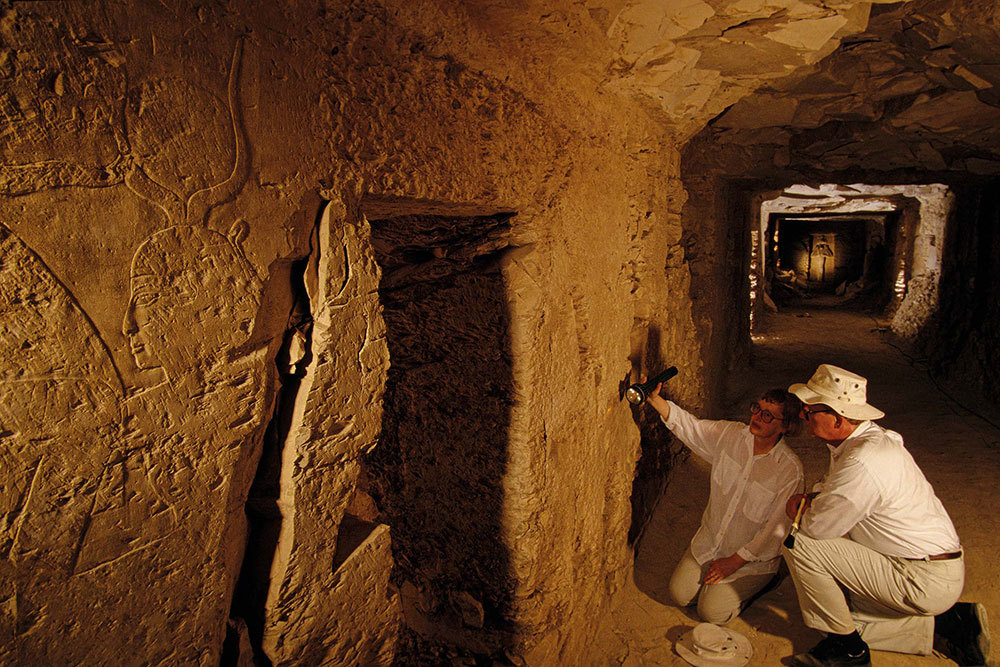 A picture of two archaeologists in a tomb