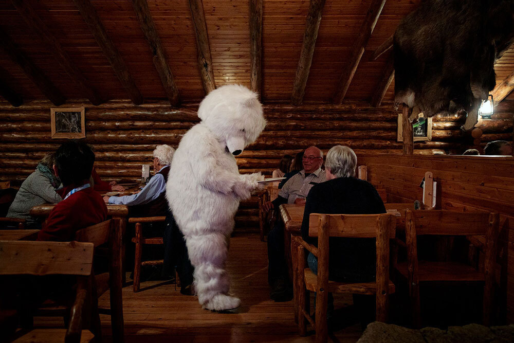 A picture of a person in a polar bear costume in a restaurant