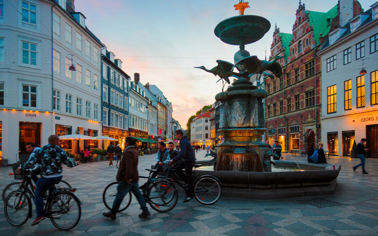 Locals pass by Stork Fountain in Copenhagen.