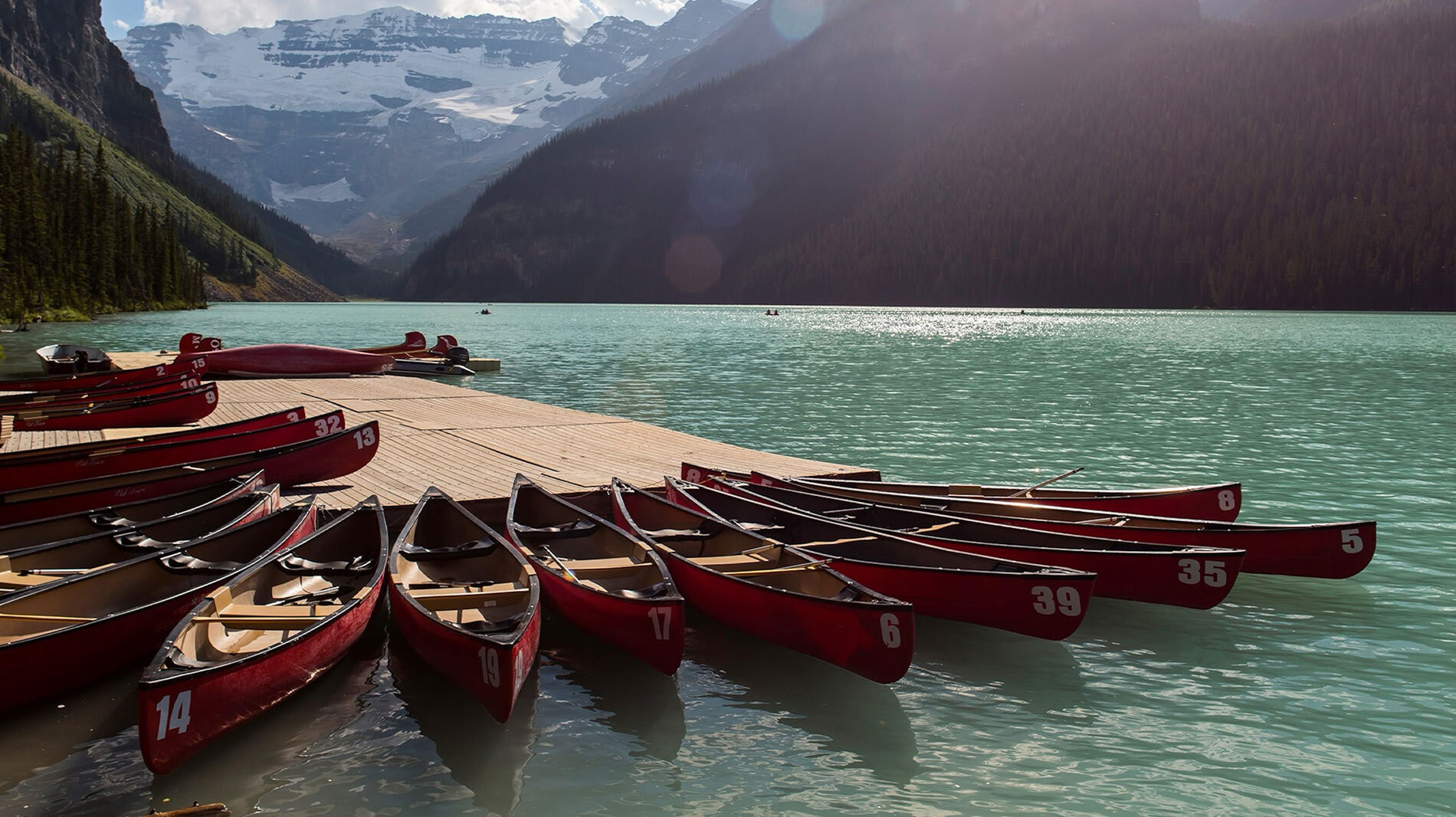 Canoes line the turquoise waters of Lake Louise.