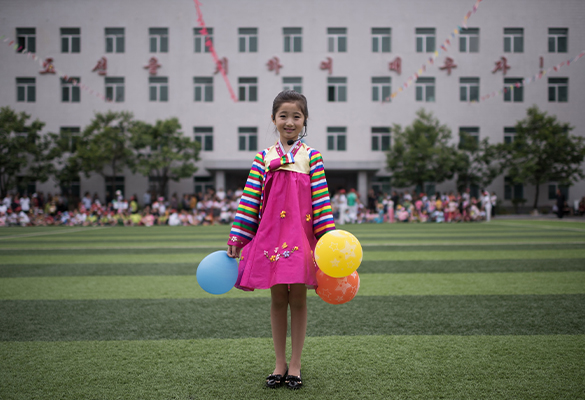 Kim Song Jong, nine, poses for a portrait following a dance performance at a Children's Day event in Pyongyang, North Korea.