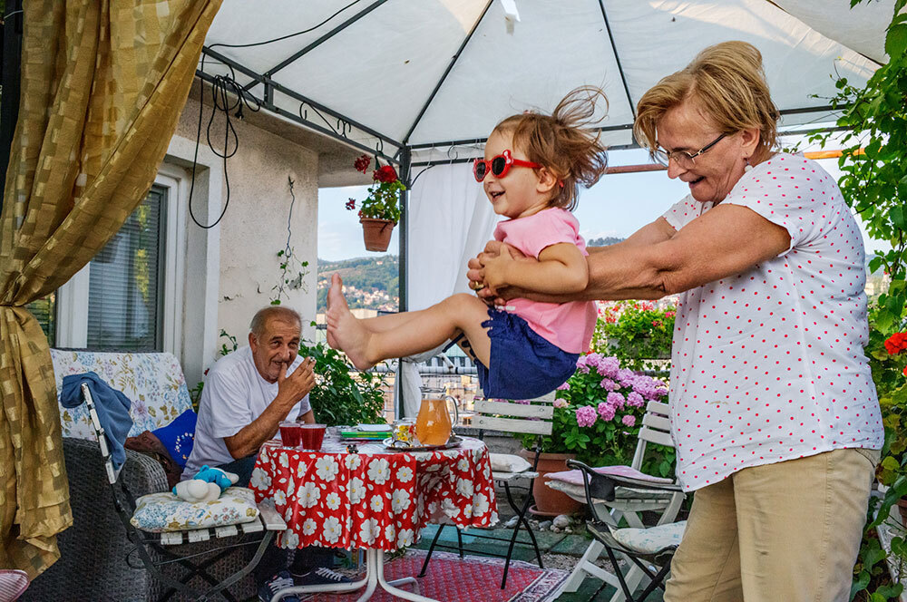 A picture of an older lady playing with a small child