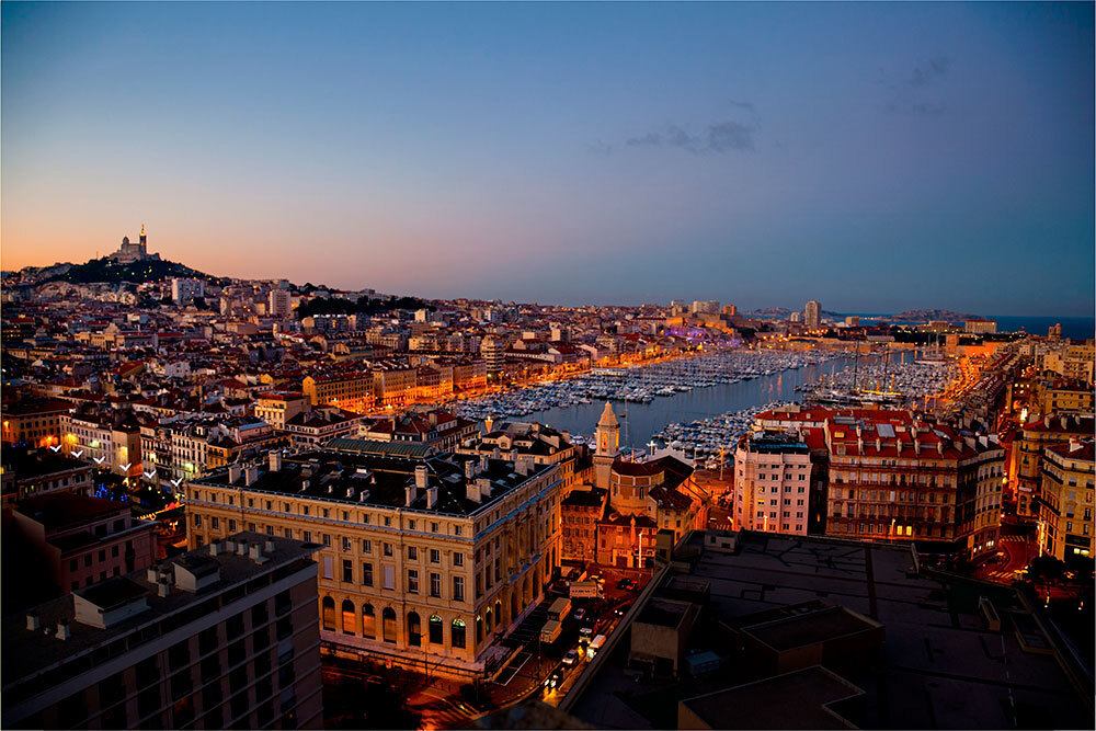 A picture of a port surrounded by multistory buildings