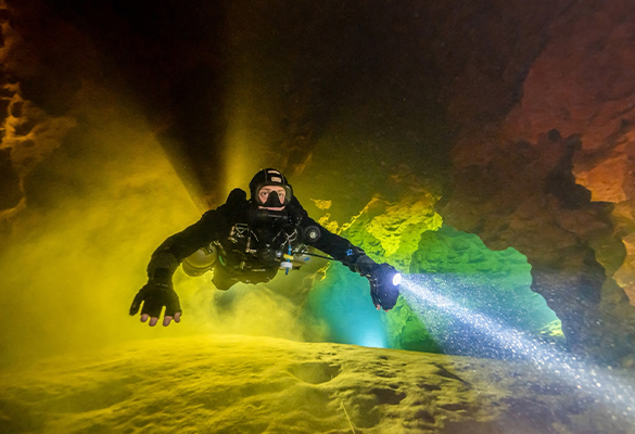 Cave diver Jaime De La Puerta Salazar swims through Peacock Springs, about 70 miles northwest of Gainesville, Florida, where green-tinged groundwater is sandwiched between river water on the cave ceiling and the silty springs floor.