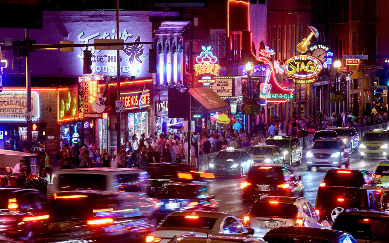 The neon lights of Lower Broadway illuminate country music bars in Nashville, Tennessee.