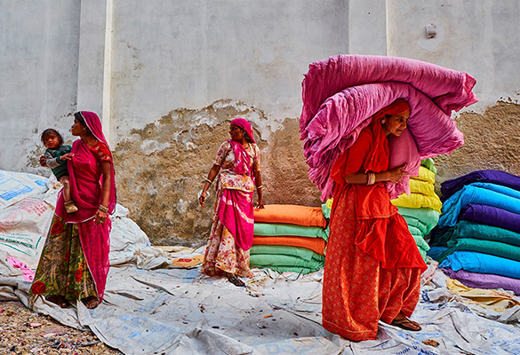 Women in Rajasthan gather up freshly dried saris at a factory. Before chemical dyes were introduced in the 19th-century, fabrics were dyed with natural materials like indigo and madder.