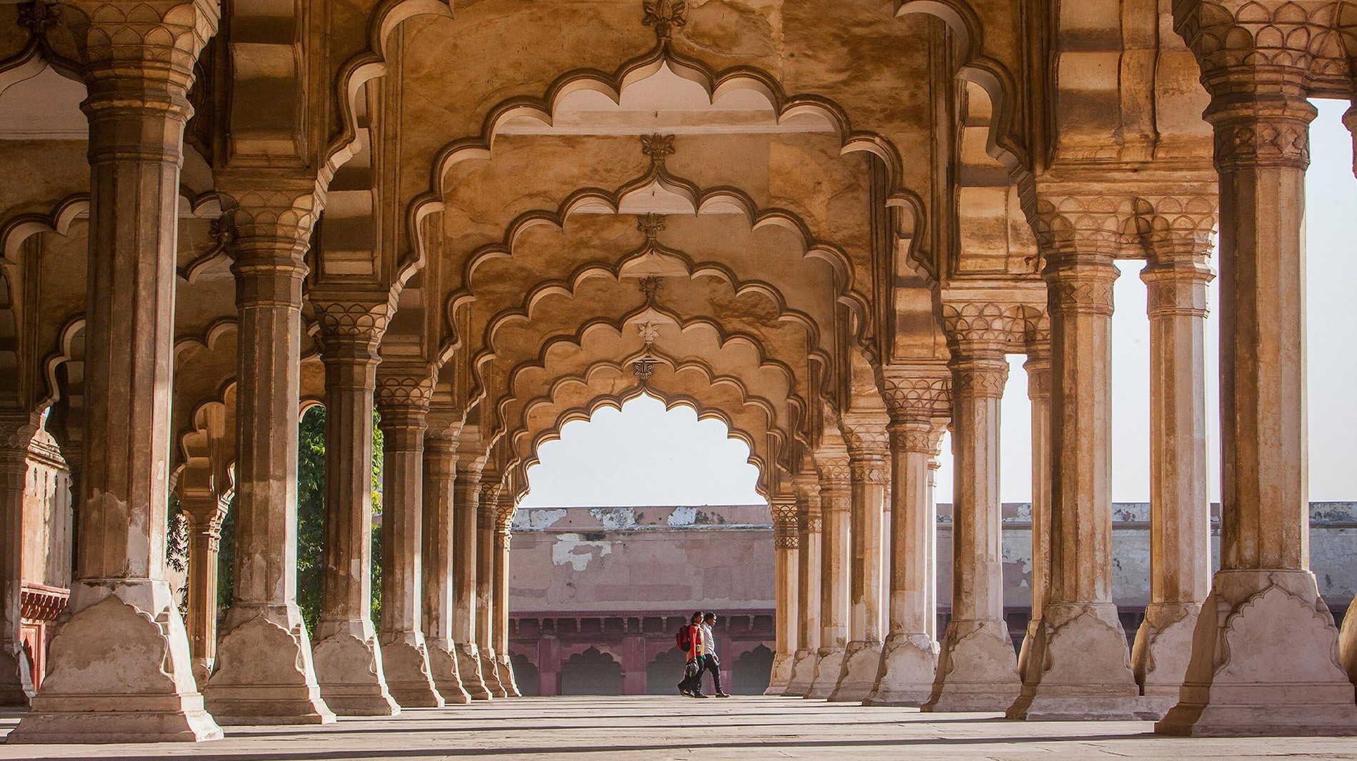 Located west of the Taj Mahal along the Yamuna River, Agra Fort is a 16th-century red sandstone complex of Mughal palaces and pearly white, marble mosques. The fort features Hindu and Islamic architecture, including jeweled floral inlays, intricate ceilings, and golden pavilions.