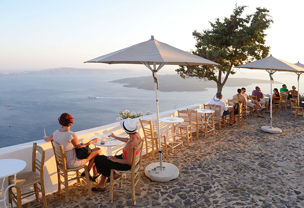 Locals enjoy the ocean view in Thira, Santorini.