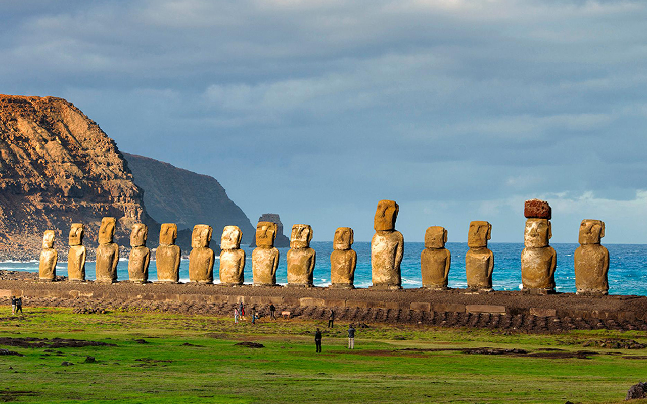 Their backs to the Pacific, 15 restored moai stand watch at Ahu Tongariki, the largest of Easter Island's ceremonial stone platforms. In 1960 these moai were swept inland by a tsunami, which fractured some.