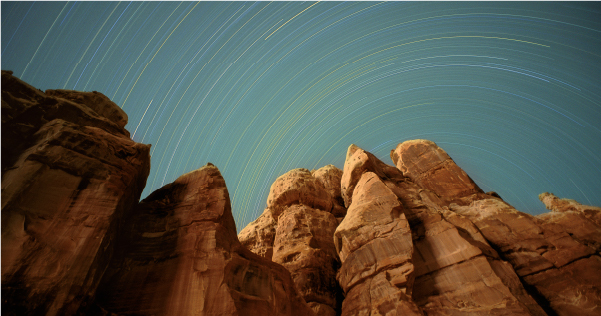 The stars are displayed in a radial pattern over a desert landscape