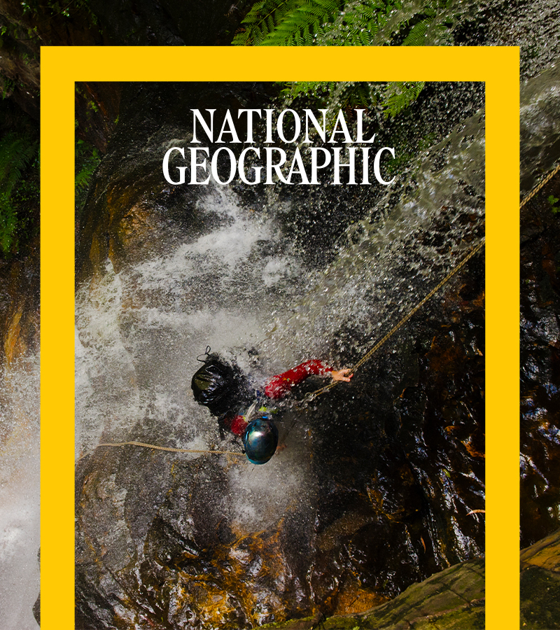 National Geographic - A person rappels down a raging waterfall.