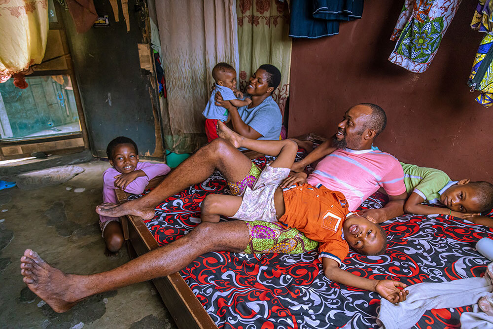 A family plays on a bed