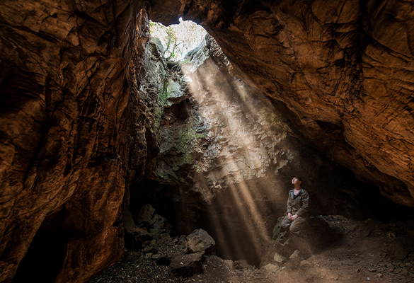 Anthropologist Marina Elliott sits at the entrance of South Africa's Rising Star cave system. Her team discovered the newfound remains in a remote passage deep in the cave's twisting network of tunnels.