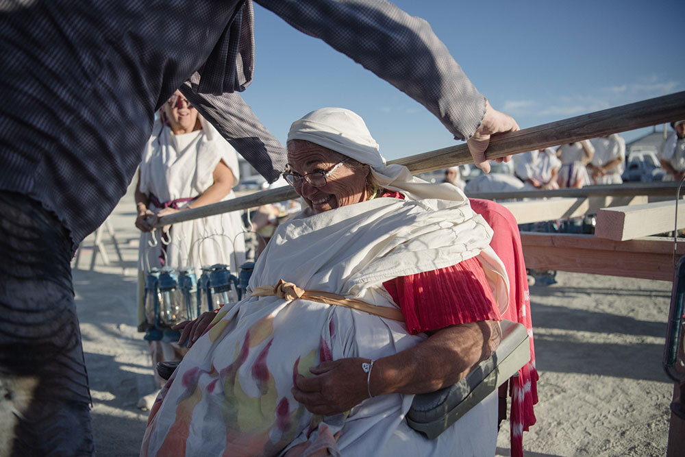 A woman bears lanterns on her shoulders