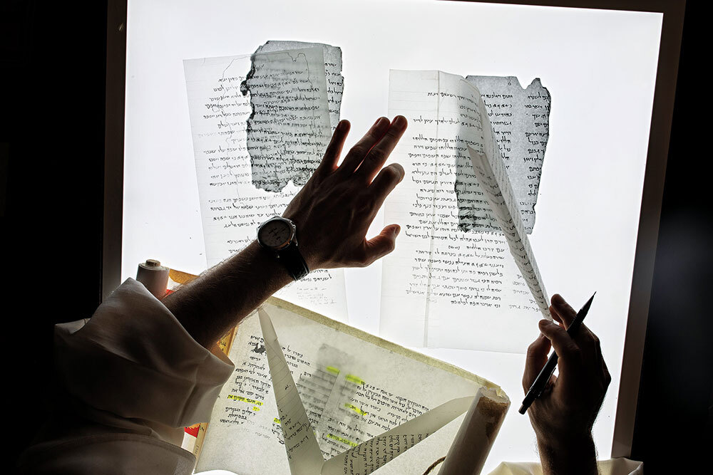 A Dominican Father reconstructs the text of a fragment of the Great Psalms Scroll at the French École Biblique in Jerusalem.