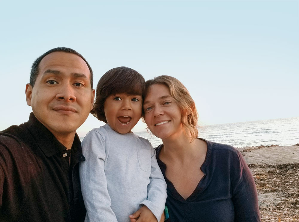 A family taking a selfie on the beach