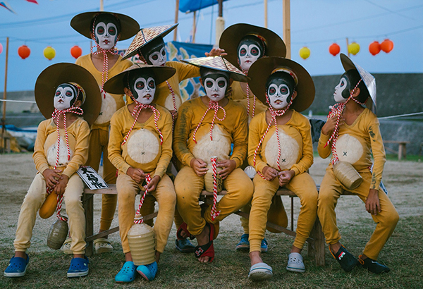 Children dressed as tanuki, or raccoon dogs, pose for a group portrait on Himeshima Island. Tanuki commonly appear in Japanese folklore as tricksters.