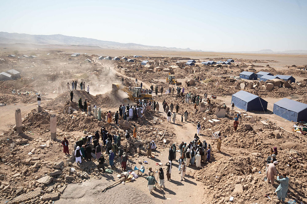 In the aftermath of a 6.3 magnitude earthquake that struck Herat, people employ construction machines and even simple tools like shovels and picks to remove the debris.