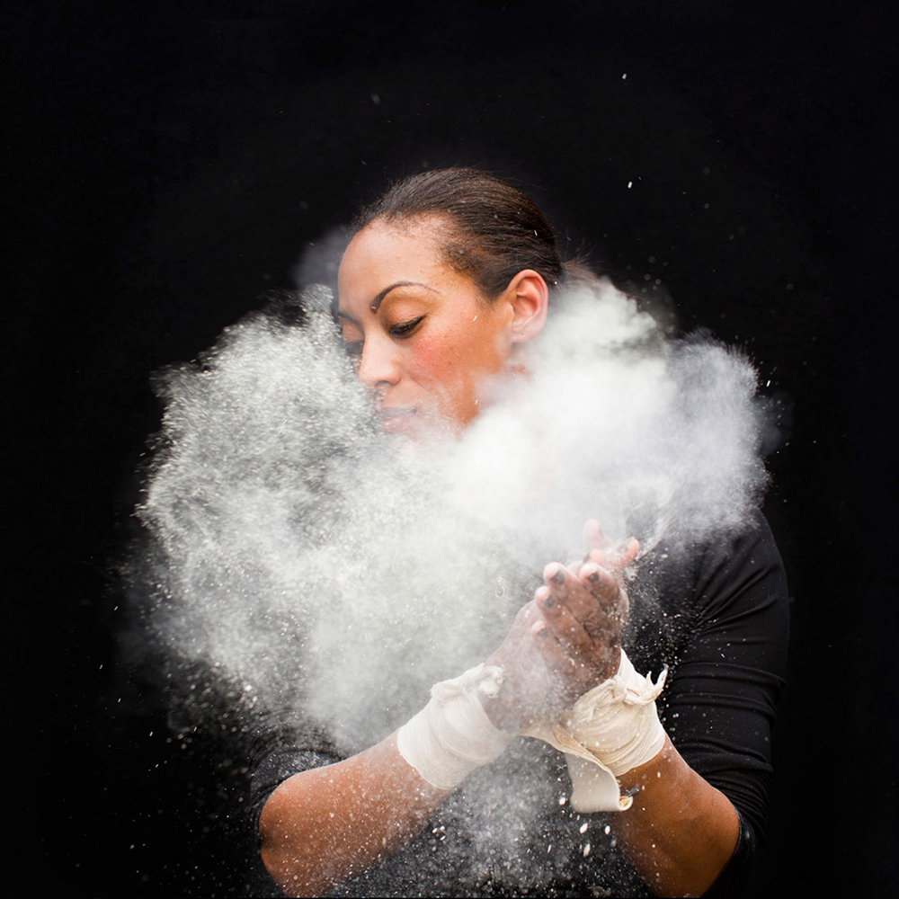 Kristin Finley claps her hands with chalk on them