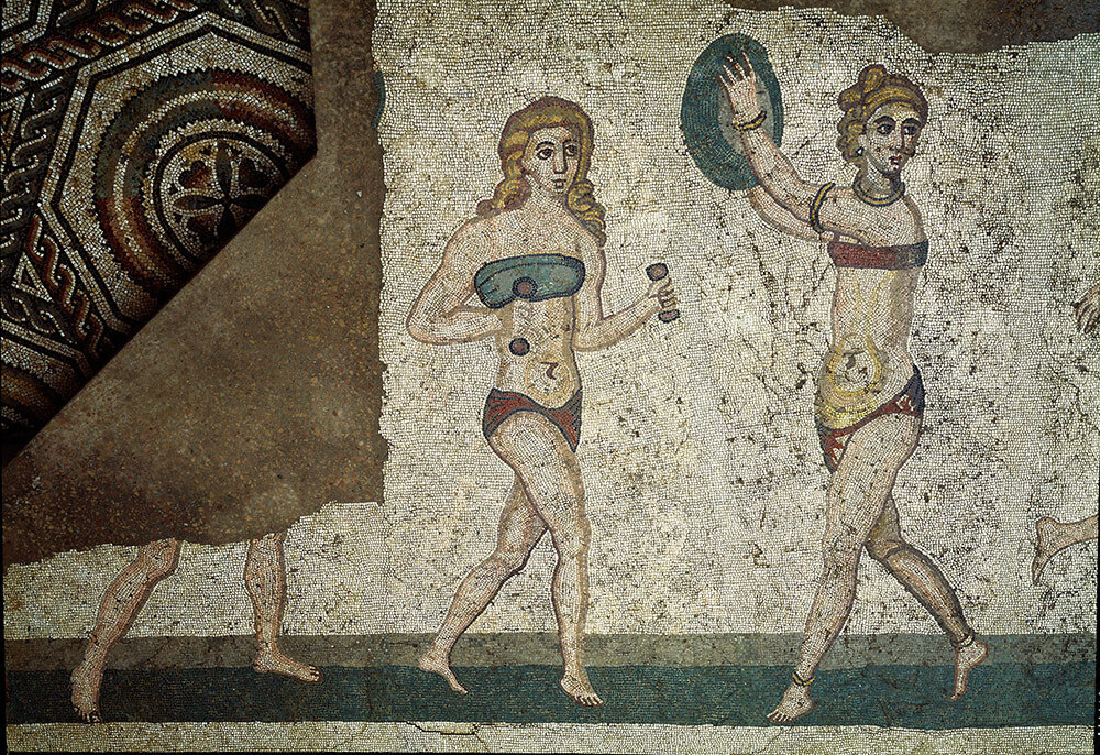 Roman women in a 4th-century A.D. mosaic from Sicily exercise while wearing an amictorium, a ancient bikini-type linen garment that bound the breasts. Scholars are divided on whether Greek and Roman women wore bra-like garments for support, style, or both.