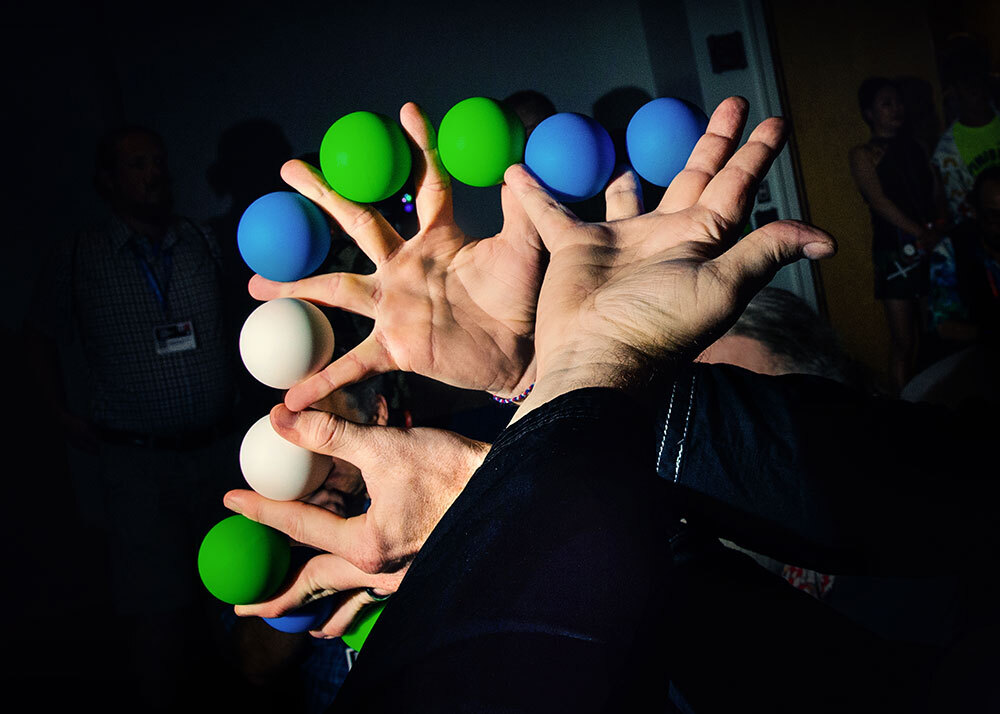 A magician's hands with colored balls