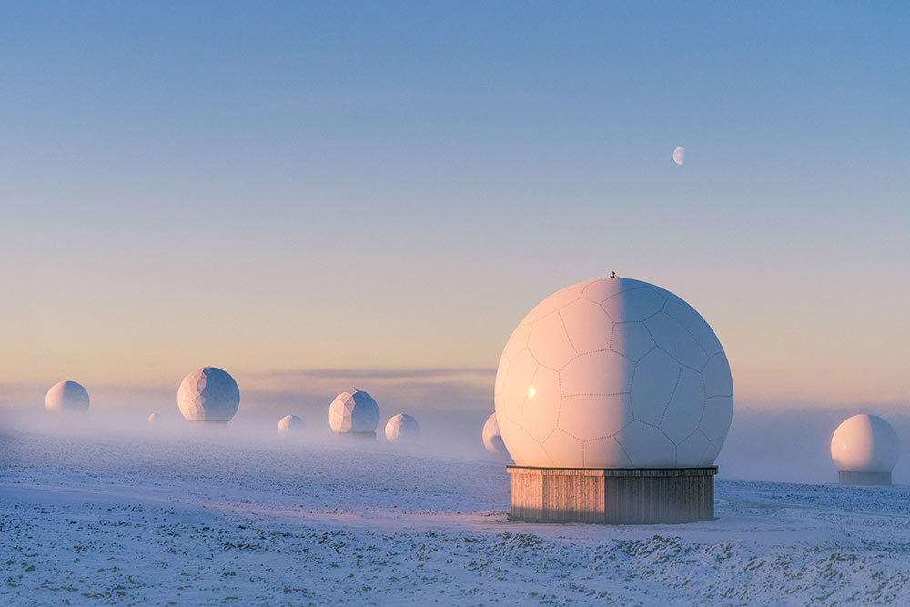 A picture of large white spheres on a cold, snowy landscape