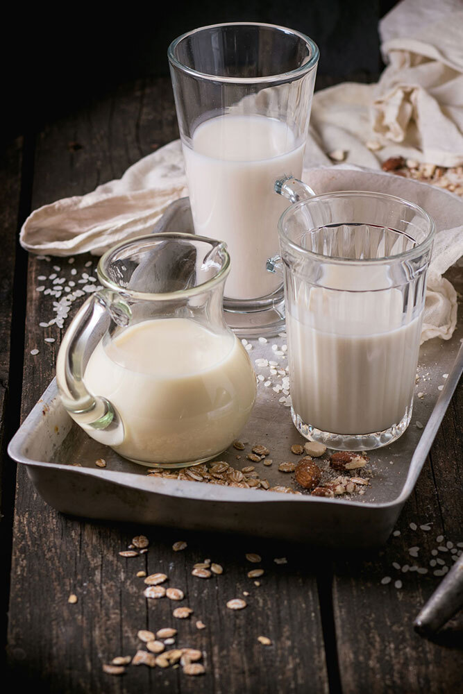 A picture of multiple glasses of milk alternatives