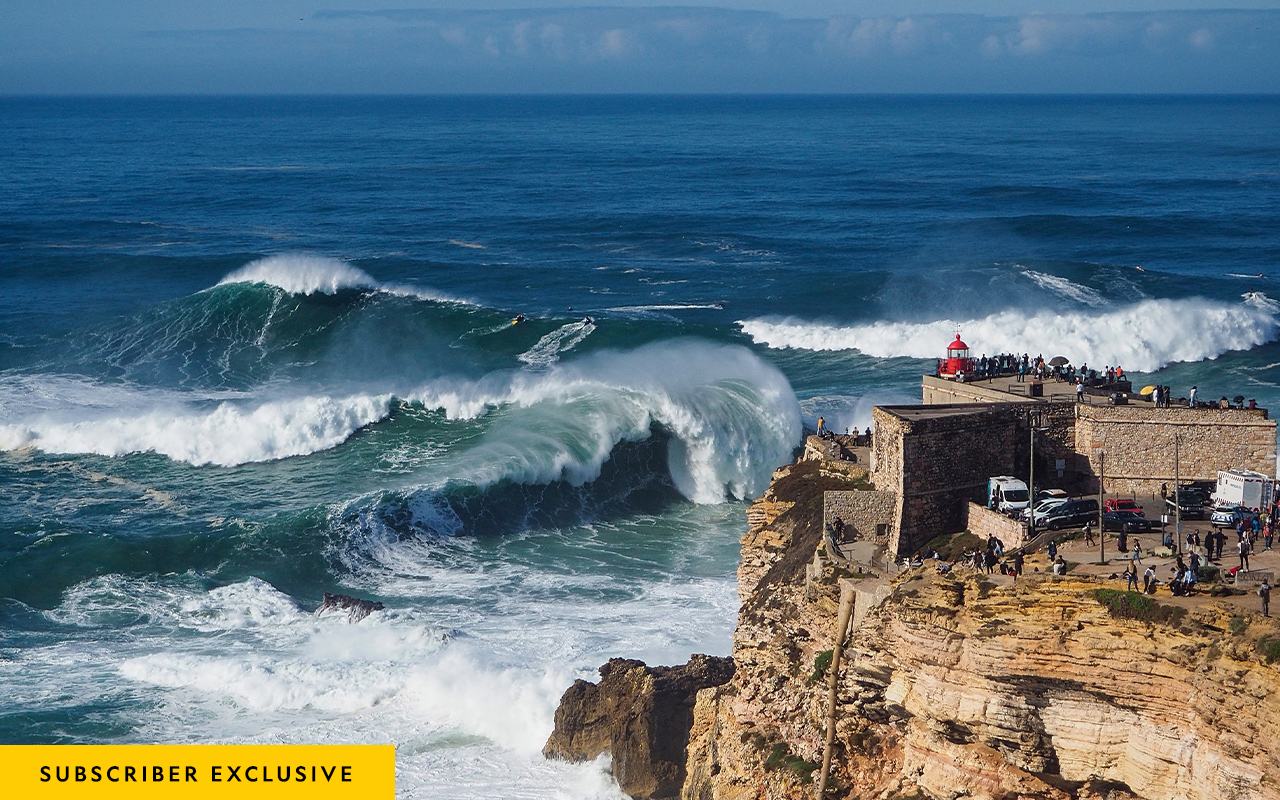 Crowds watch big-wave surfers from the lighthouse atop Nazaré’s Fort of São Miguel Arcanjo, on October 29, 2020.