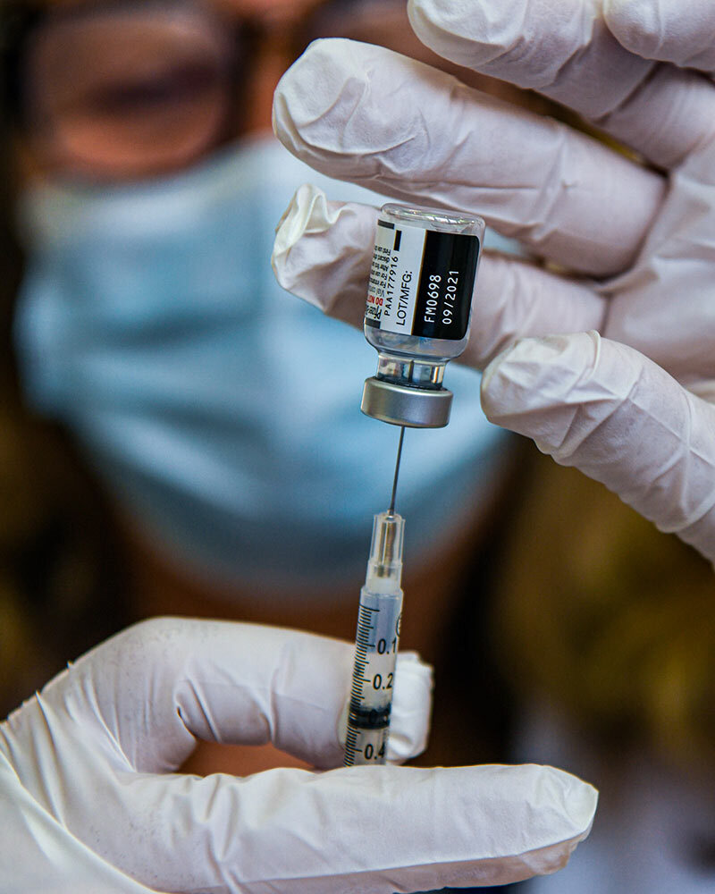 A pharmacist prepares a COVID-19 booster shot in the vaccination clinic at Meritus Medical Center in Hagerstown, Md.