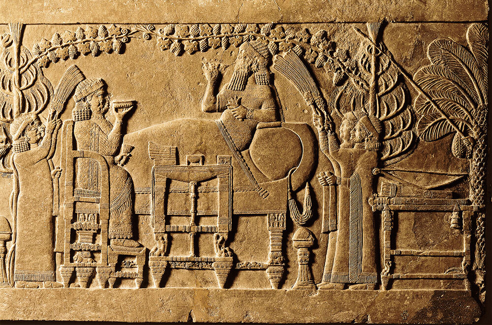 A wall fragment carved in low relief shows Ashurbanipal and the enthroned queen in an arbor celebrating the defeat of Elam.