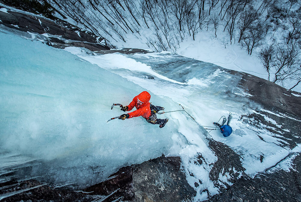 A picture of a man ice climbing