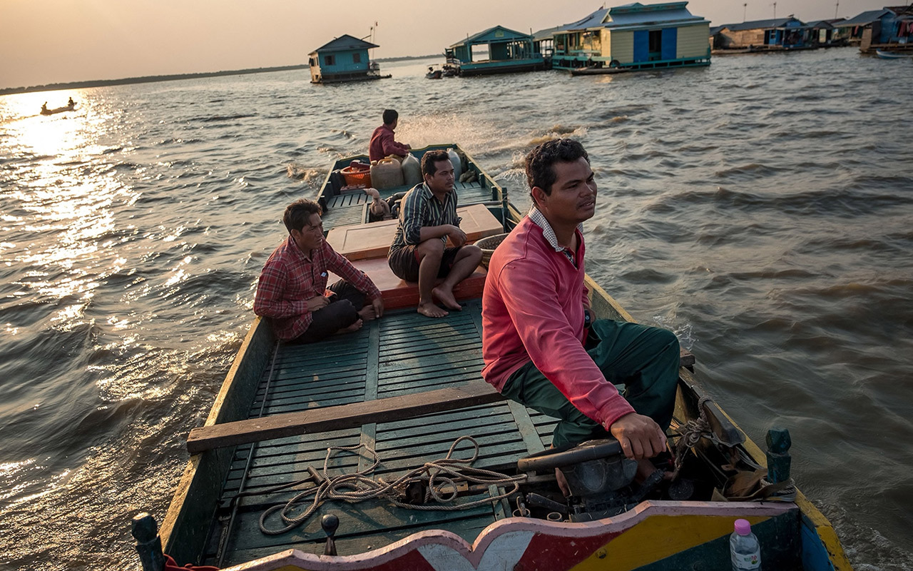 Phoen Sok Phoen, a fisherman who caught 250-plus-pound giant barb in his net on two separate occasions last year but called the fisheries officials to release the fish, drives his boat back home through Kompong Loung floating village on Tonlé Sap Lake, Cambodia. It was the first time in 10 years of fishing the Tonlé Sap Lake that he’d caught one giant barb, let alone two. “I was very surprised and very afraid, because giant barb is like a god or spirit,” he says. “I prayed to it, ‘Please don’t harm me!’”