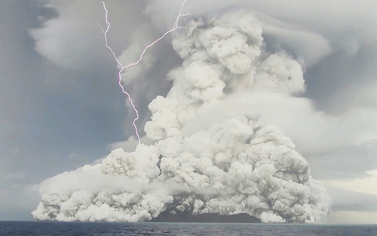 An eruption occurs at the underwater volcano Hunga Tonga-Hunga Ha'apai off Tonga, January 14, 2022 in this screen grab obtained from a social media video. Video recorded January 14, 2022.