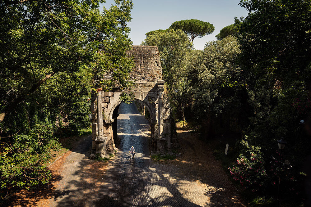 A picture of someone riding a bike along a stone path