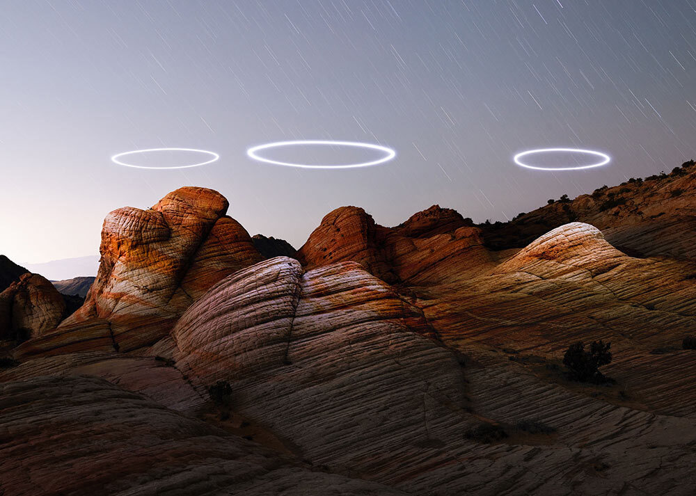 programmed lit drones circle above Utah’s Yant Flat sandstone formations