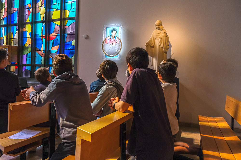 Young students attend the relic installation mass for Carlo Acutis at the Lycée Notre-Dame de la Galaure