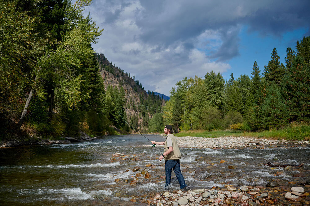 a person fishing on a river