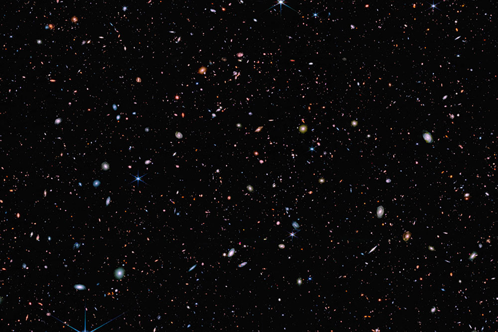 A picture of galaxies speckled across inky blacknes