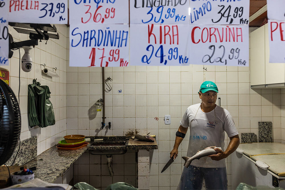 At one stall in the city of Aracruz, vendor Robson da Vitoria Rodrigues prepares a Caribbean sharpnose shark for his customers.