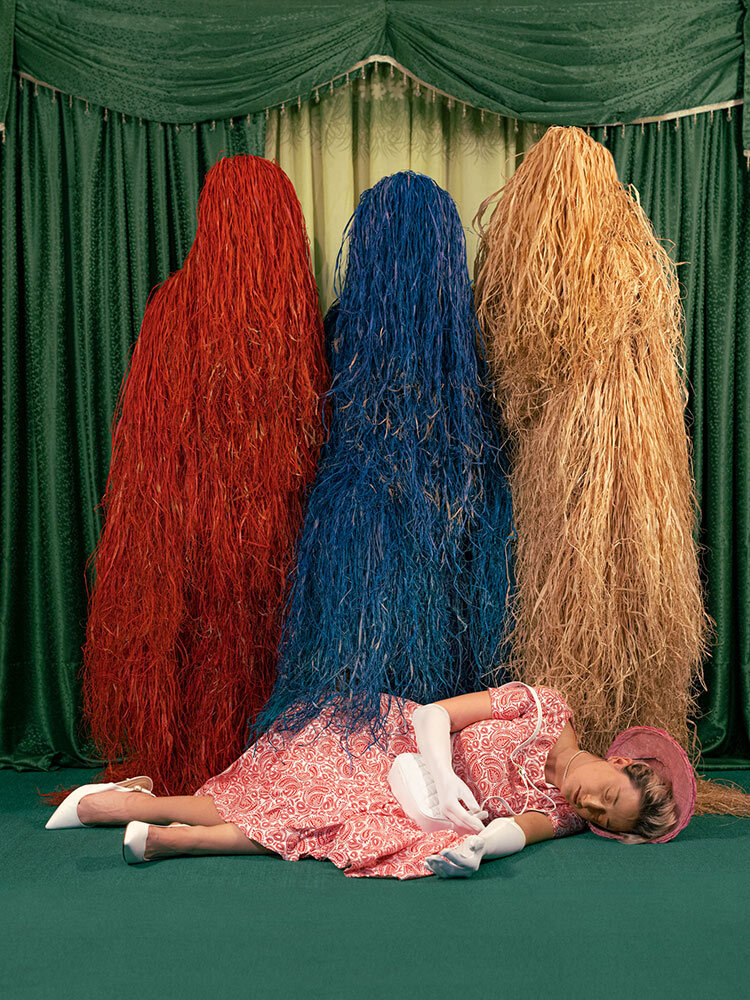 a woman poses for a reenactment of the 19th-century English fairy tale Goldilocks and the Three Bears