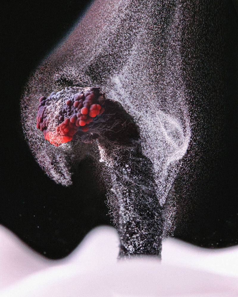 Particles from a puff of smoke surround a candle wick