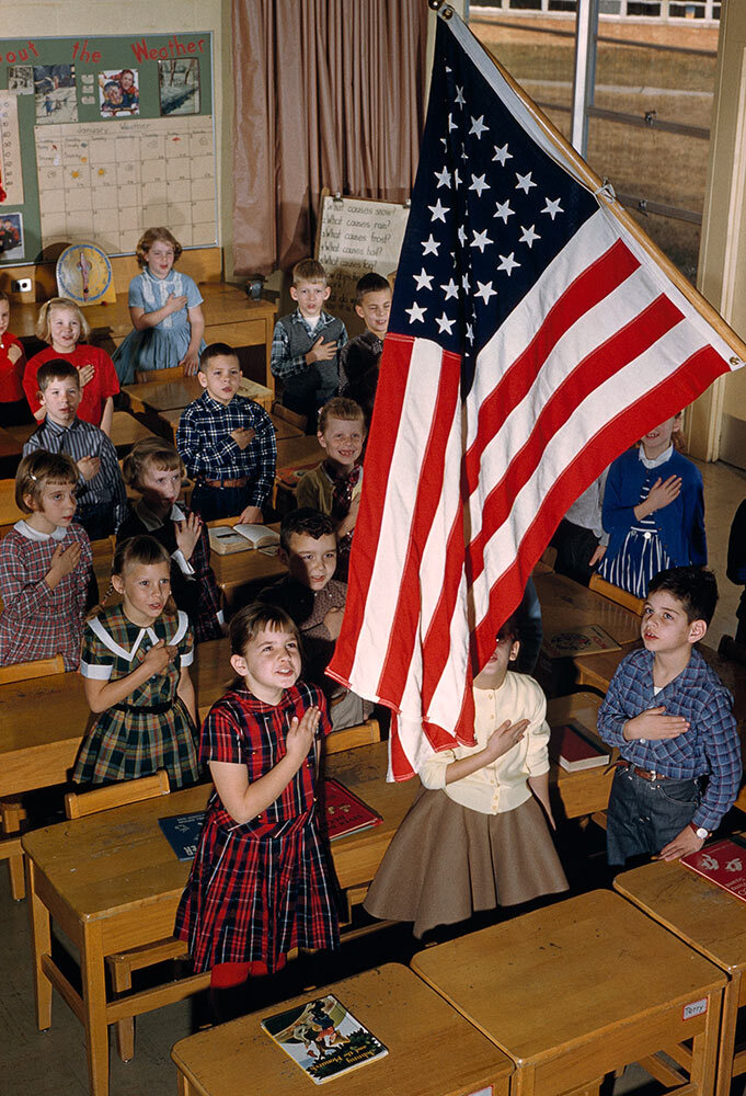 American children pledge allegiance to the flag at a Virginia school, 1959.