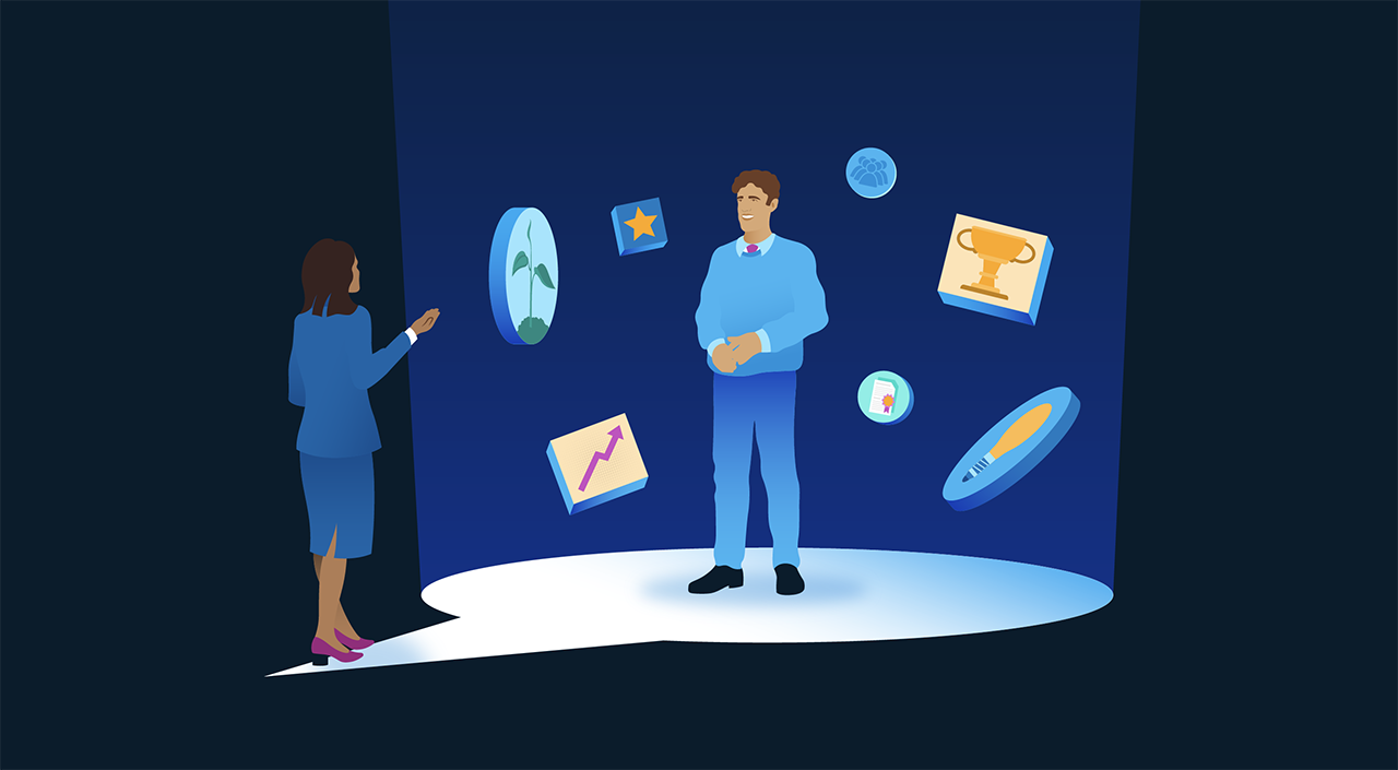 Image description: An image of a supervisor delivering a performance review to an employee. The employee stands in the foreground, illuminated by a spotlight, and is surrounded by various images (including a trophy, a lightbulb, and a star) that represent employee performance and achievement. The spotlight pools into the shape of a speech bubble at the supervisor’s and employee’s feet, representing feedback. End of image description.