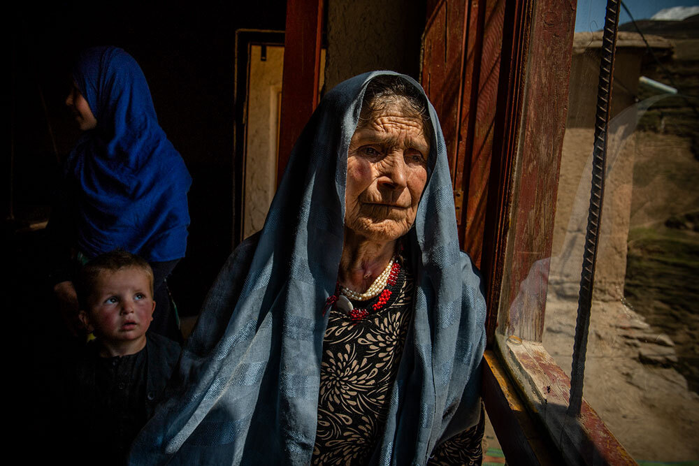 A picture of an older woman near a window