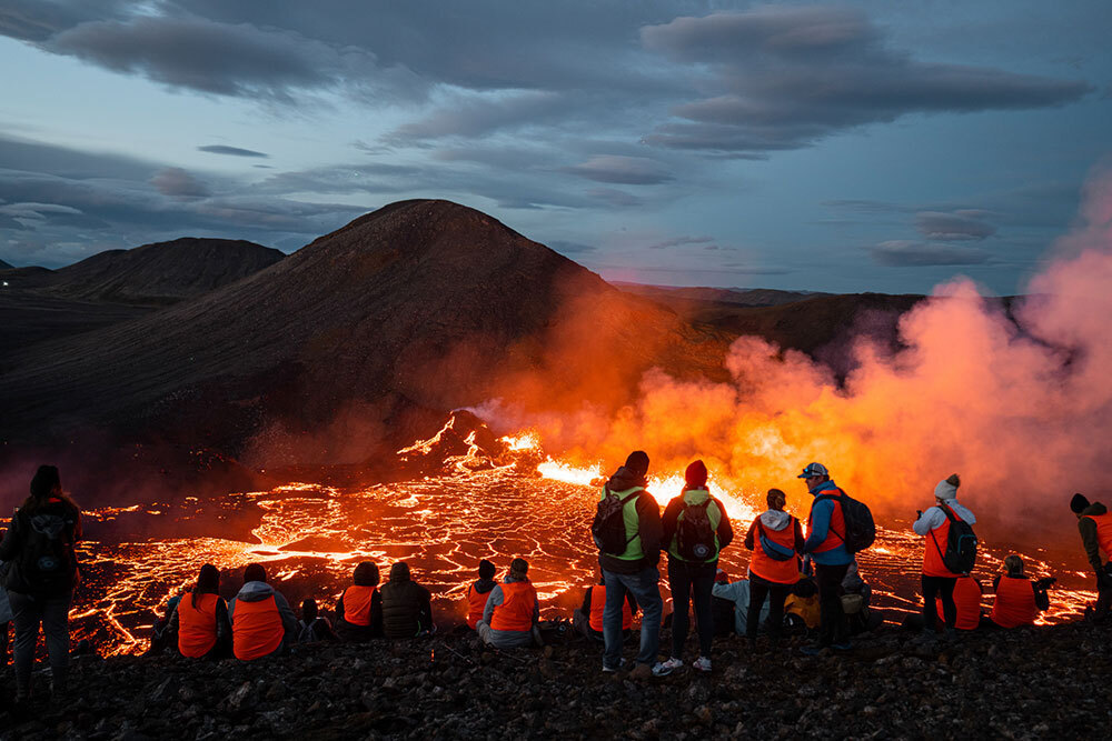 A picture of people watching a volcanic eruption in Iceland