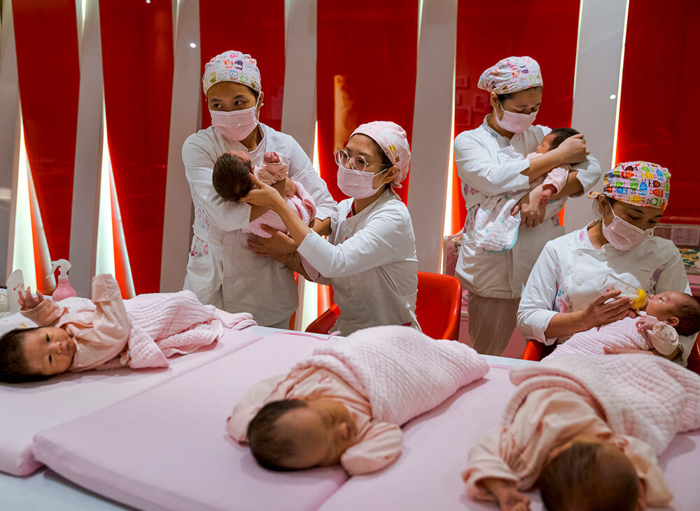 caregivers tending to babies in a postnatal center in China