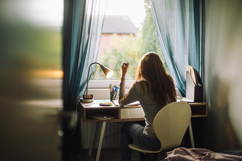 A woman works at a desk