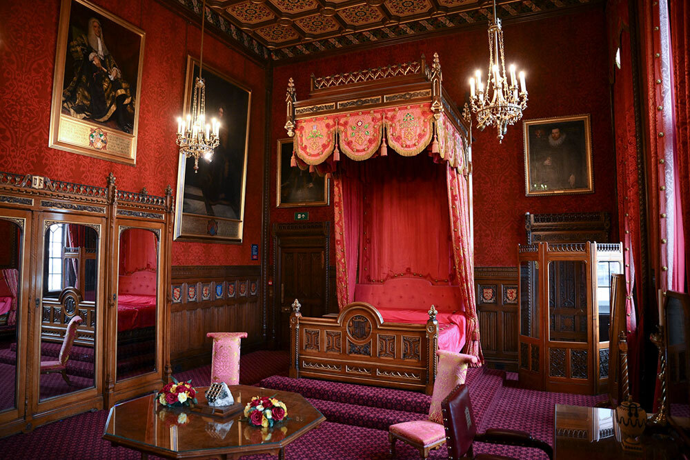 a red canopy bed used during the coronation in a red room