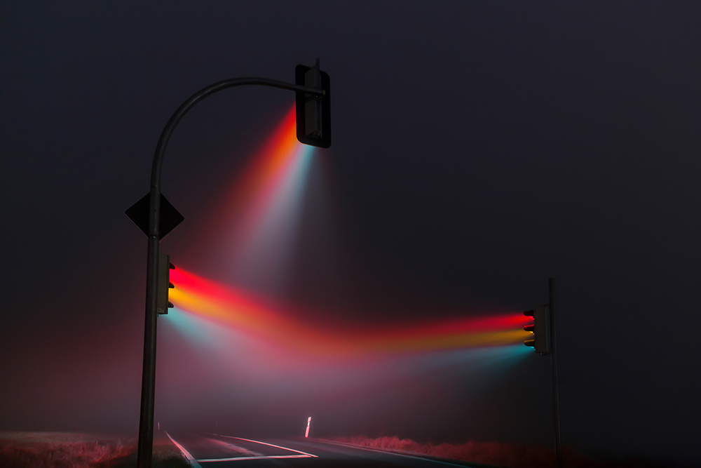 Photographs can capture multiple moments in time, such as this image of traffic lights shot with a long exposure on a foggy night near Weimar, Germany.